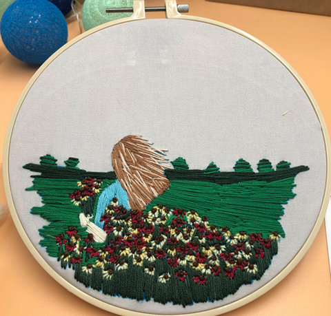 Light Brunette Woman in Green Field Embroidery